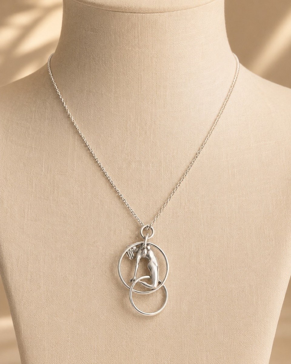 Sterling silver pendant of a stylised gymnast figure suspended within flowing circles, on a fine chain
