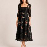 Black lace midi dress with red, pink and green floral embroidery, square neckline and three-quarter sleeves, front view