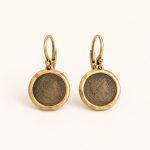 Pair of gold-tone drop earrings framing antiqued Roman-emperor coin reproductions on lever-back hooks